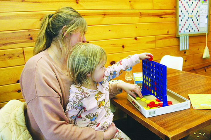Coollaborate co-owner Andrea Bell and her daughter Scottie play Connect Four.