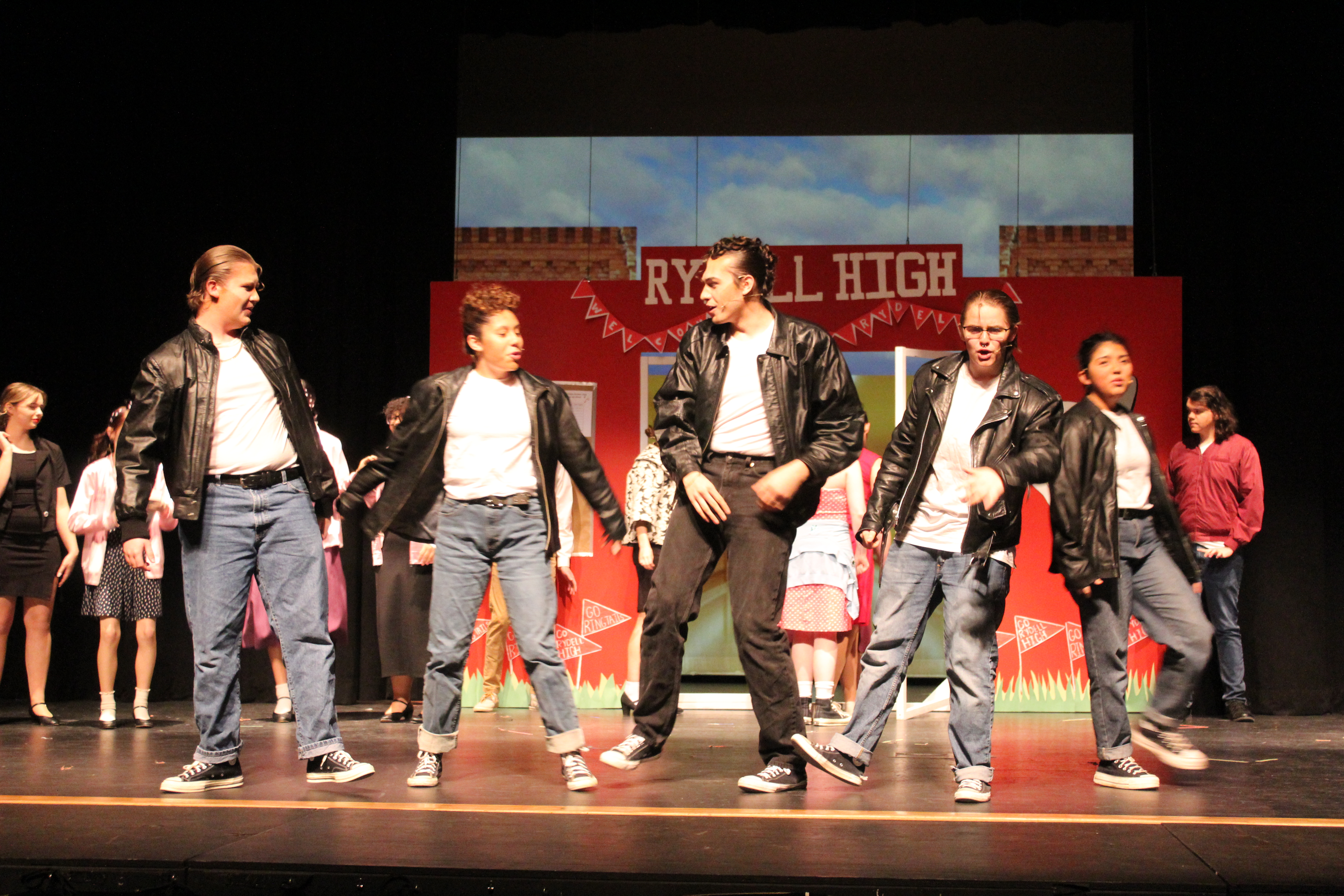Grease will open this Friday on stage at Swain Arts Center. Students playing Greasers are pictured in the show's opening song. From left is Hunter Smith, Eva Bottchenbaugh, Luca Crawford, Memphis Taylor, and Cecilia Solano Jumper.