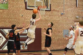 Maroon Devil Noel Wolf added 16 points for the Devils in the win over Rosman. Above, he goes for the net in the home loss to Franklin. 
