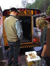 Staff loads the bus with student meals