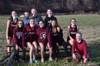 Photo by Joanna McMahan The Lady Devils cross country team is pictured at the beginning of the season. The first part of this short season has been a strong one for the team. 