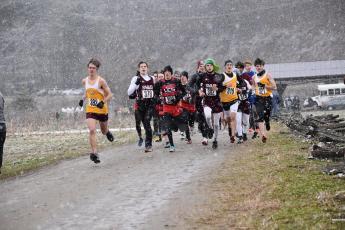 Swain County Maroon Devils cross country team is pictured with other competing teams at the regional match held Saturday at Kituwah Mound amid cold temperatures, wind and snow.