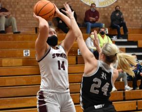 Photo by Kevin Hensley/Graham Star Lady Maroon Devil Savannah Smith fends off a Robbinsville Lady Knight and takes a shot. 