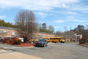 Buses are lined up outside East Elementary along with a Swain County SRO vehicle near the end of the school day on Monday. Elementary students in Swain County will be able to attend in-person four days a week beginning Monday, Feb. 22. 