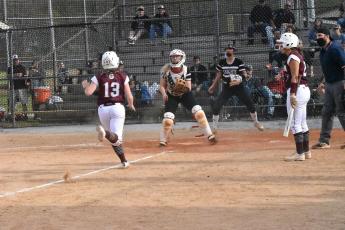 Lady Maroon Devil Kierston Smith races to home plate in the game against Lady Black Knights.