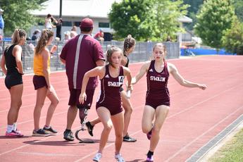 Lady Devil Emily Ulaner hands off to Amaya Hicks in the 4x400 relay at regionals.