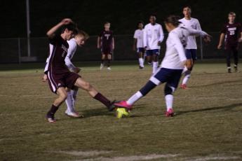 Maroon Devil defender Levi Trantham battles it out for the ball against two Stallion players.