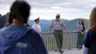  National Park Service Director Chuck Sams and Rear Admiral Denise Hinton speak to students and staff on National Public Lands Day Saturday.
