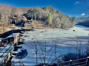 The water above Ela Dam Tuesday morning is frozen over and covered with a dusting of snow.