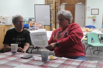 Cynthia Womble, right, shares the library renovation plans during Coffee at the Library held Tuesday.