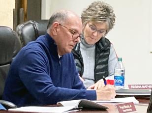 Sam Pattillo and Regina Mathis take notes during the town board meeting Monday.