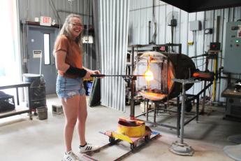 Glassblower apprentice Rachel Raming at the Green Energy Park works with one of the ultra-hot furnaces – which are powered by the nearby landfill.