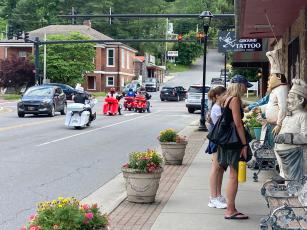 Visitors to Bryson City look at the menu outside Pasqualino's Italian Restaurant on Tuesday. 