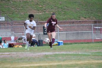 Lady Devil Karena Cline battles for the ball at Monday’s playoff game.