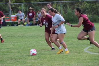 Maddie Lay (from left), Kyndall Cochran and Abigail Durisseau vie for the ball at the alumni women’s soccer game on Friday, Aug. 4.