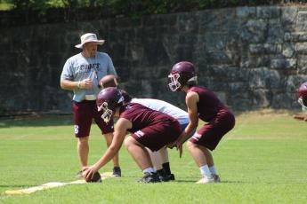 Coach Sherman Holt directs Maroon Devil athletes during a football drill at practice recently.