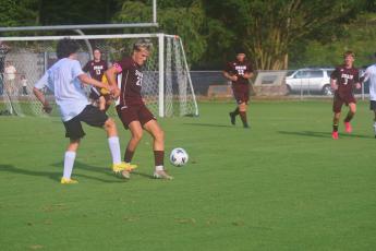 Owen Craig fends off an opponent from North Buncombe at Monday’s game.
