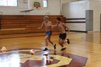 Maroon Devils Owen Craig (left) and Kyle Nguyen vie for the ball during practice.