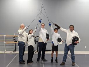 Smoky Mountain Fencing Academy has classes on Wednesday nights from 5-7:30 p.m. at Pirouettes studio. Pictured are the instructors Jim Paintiff (far left) and Joe Holt (far right) with students.