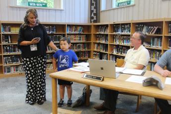 West Principal Lisa Sutton (left) recognizes student Christoph Ensley for good character at the Monday, Sept. 11 school board meeting, held at the middle school media center.