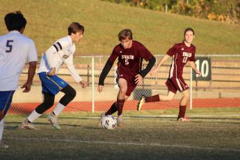 Brendan Lanning (from left) and McClane Whorton maneuver the ball around the field at the soccer game from Wednesday, Oct. 18.