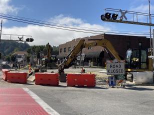 Contractors work on utility upgrades on Everett Street Monday morning. 