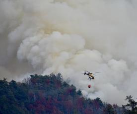 A heavy-lift helicopter prepares to drop water from a bucket on a hot spot in the Collett Ridge Fire east of Pisgah Road in Cherokee County near Andrews on Thursday.