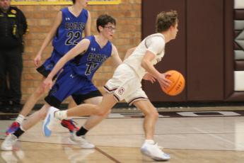 Maroon Devil Reese Winchester takes hold of the ball and gets ready to shoot at Tuesday’s game against the Eagles.