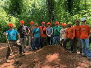 Several members of Nantahala Area SORBA pose with Trail Dynamics, which works on building new mountain bike trails.