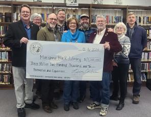 Jeff Delfield, Swain County librarian and Ellen Snodgrass, Marianna Black Library Board chair (center) accept a $3.2 million from Senator Kevin Corbin (left) and Rep. Mike Clampitt. Pictured back row from left are MBL Board members Cynthia Womble, Christian Siewers, Swain County Commissioner Kevin Seagle, and MBL board members Mary Danals and Anthony Monnat.
