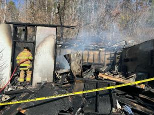 Firefighters continue to work at a structure fire on Hughes Branch Road. The building was a standalone garage with an apartment above. No one was injured in the fire that started Sunday afternoon. 