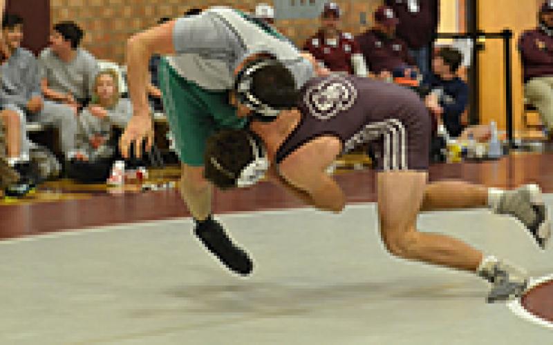 Maroon Devil Thomas Allen knocks his opponent off his feet at the Devil Duals held at Swain County High School on Saturday.