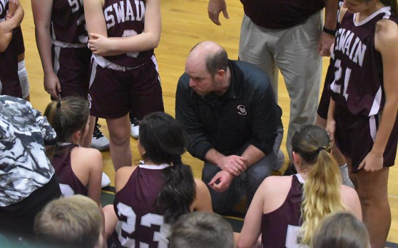 Coach Michael Turner talks to his athletes of the Swain County High School girls basketball team