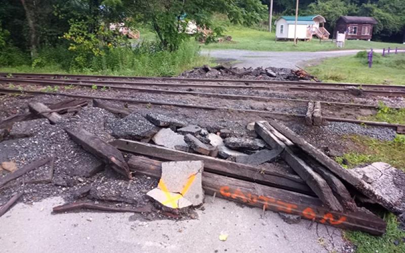 The road is torn up where it had gone over the tracks