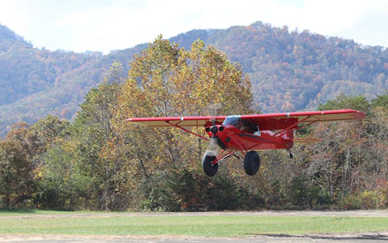 A red plane lands