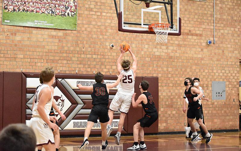 Maroon Devil Isaiah Collins closes in on the basket in the home court 84-41 win against Rosman. 