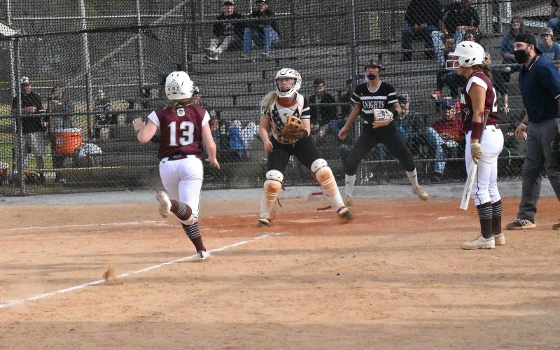 Lady Maroon Devil Kierston Smith races to home plate in the game against Lady Black Knights.