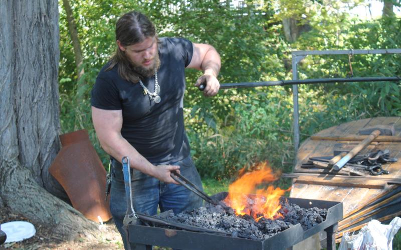 a blacksmith display, drawing festivalgoers in as they first enter the field