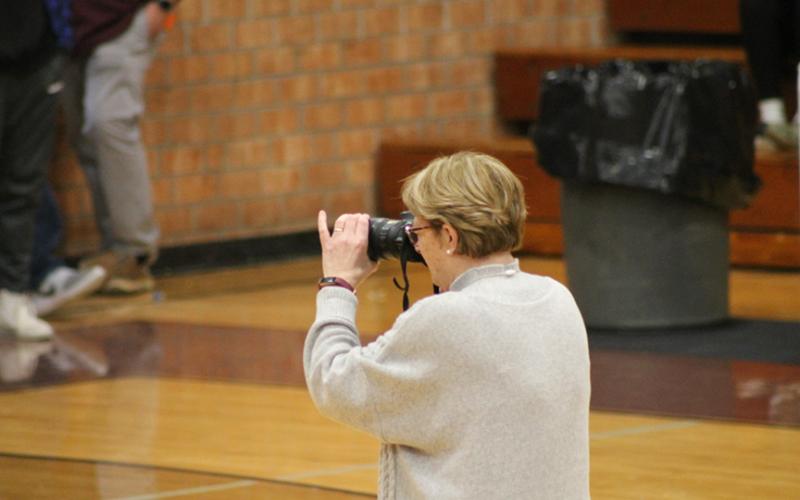 Joanna McMahan takes pictures at a SCHS basketball game