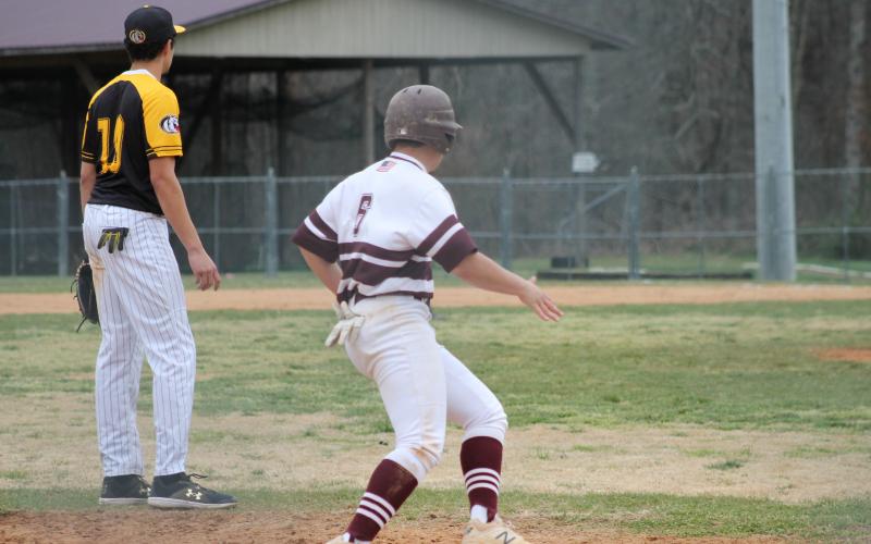 Senior Will Jenkins attempting to steal home from third base 