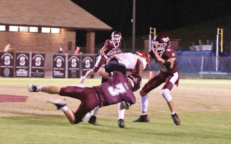 Photo by Joanna McMahan Swain Maroon Devil Josh Collins takes down a Phoenix player with Reece Winchester ready to back him up at the first playoff win last Friday.