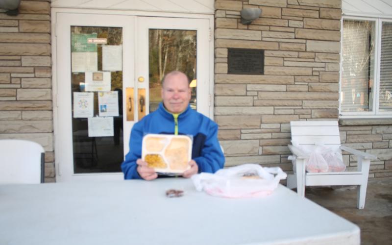 Mike Colcord, a volunteer with The Giving Spoon, gets ready to hand out meals at the Bryson City Presbyterian Church.Credit: Larry Griffin/SMT
