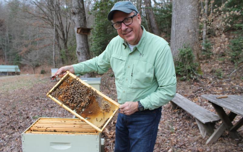 Fred Crawford, president of the Smoky Mountain Beekeepers Association, shows off one of his beehives at his farm in Whittier.