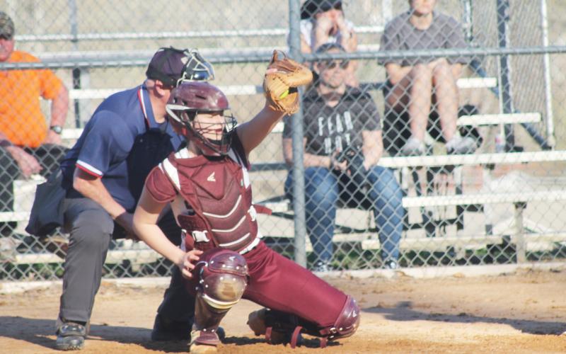 Carley Teesateskie catches a pitch as the Lady Devils played the Rosman Tigers on Tuesday, Feb. 28.