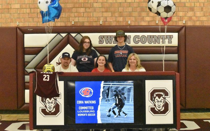 Lady Devil Cora Watkins signed to continue her soccer career with Louisburg College in a ceremony held at the Swain High gymnasium recently. She’s pictured with her family.