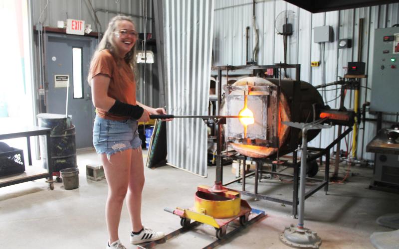 Glassblower apprentice Rachel Raming at the Green Energy Park works with one of the ultra-hot furnaces – which are powered by the nearby landfill.