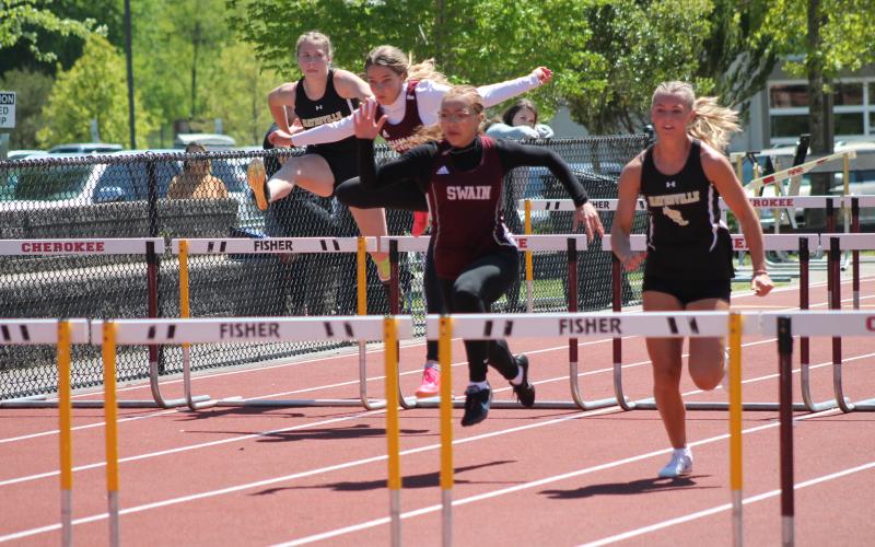 Lady Devils Melanie Linton (lead) and Kinsley Hyatt participating in one of the hurdle relay events at the SMC Track & Field Championships on May 3.