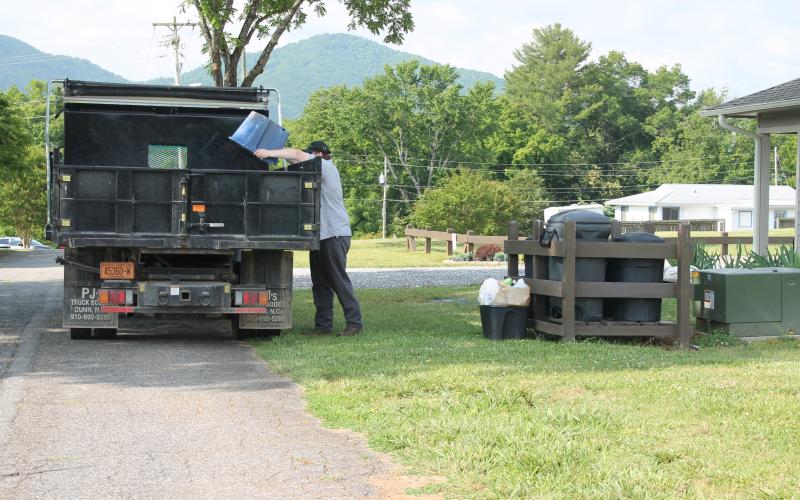 Bryson City town worker Logan McCall runs the residential recycling pick-up on Wednesday morning. He's pictured here collecting recyclables from homes on Hospital Hill.