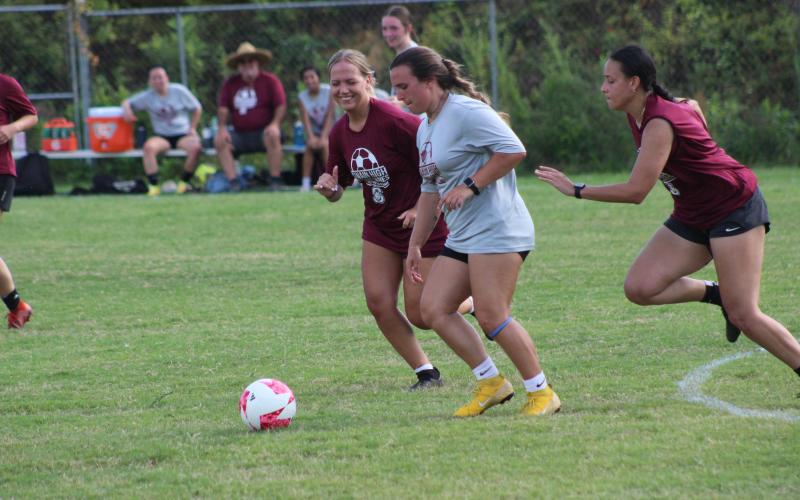 Maddie Lay (from left), Kyndall Cochran and Abigail Durisseau vie for the ball at the alumni women’s soccer game on Friday, Aug. 4.