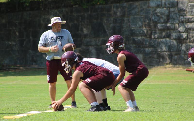 Coach Sherman Holt directs Maroon Devil athletes during a football drill at practice recently.